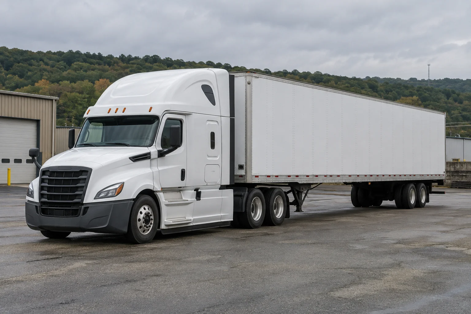 Unbranded white tractor and trailer on an industrial road with wooded hills